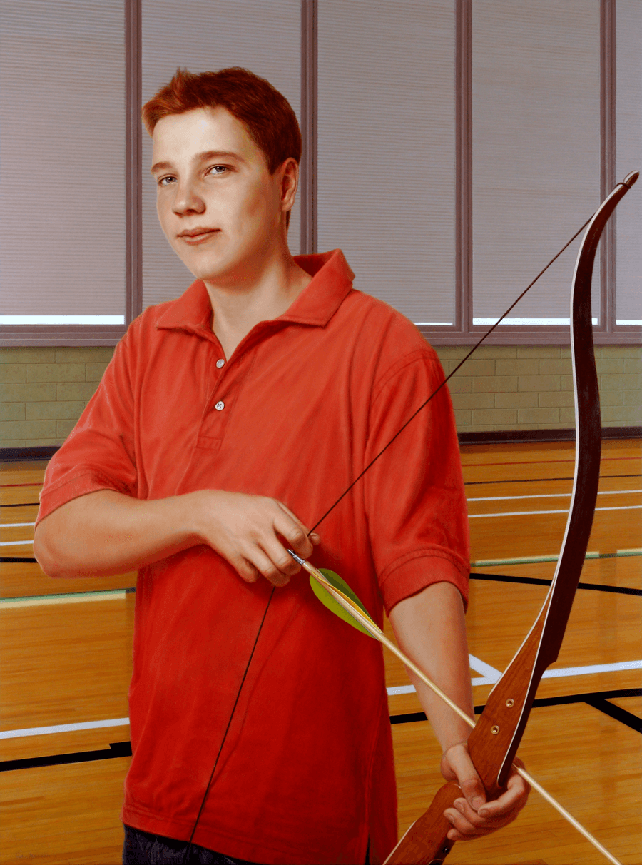 A realist oil portrait titled 'Archer,' measuring 39 inches by 29 inches. A young man with short, reddish-blonde hair and a calm expression stands in a gymnasium, holding a wooden recurve bow. He wears a bright orange-red polo shirt and blue jeans, with an arrow nocked and resting against the bow’s riser. The background shows the polished wood of a gym floor with painted court lines, a green-blocked lower wall, and large windows with nearly closed horizontal blinds. The lighting is bright and even, highlighting the smooth finish of the bow and the subject's relaxed posture. Oil painting by John Hansen.