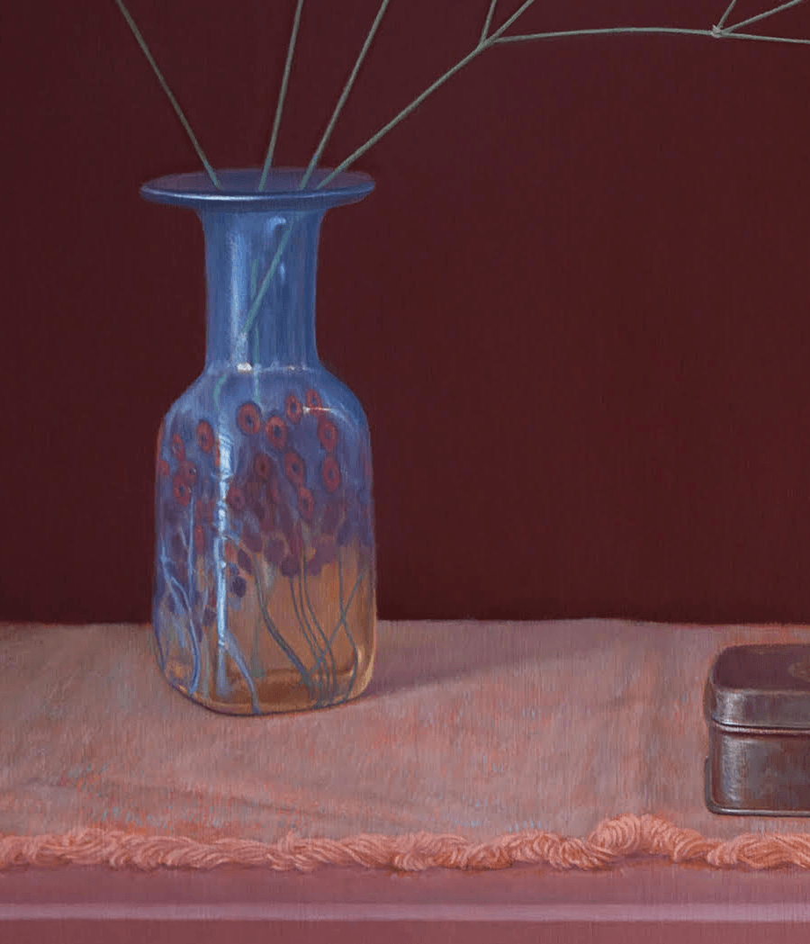 A detailed close-up from the oil painting 'Baby's Breath in a Glass Vase'. This view highlights the translucency of the blue glass and the fine, painterly red floral decorations at its base. The delicate stems of the baby's breath are visible through the neck of the vase, set against the soft texture of the fringed peach cloth and the matte finish of the metal tin. Oil painting by John Hansen.