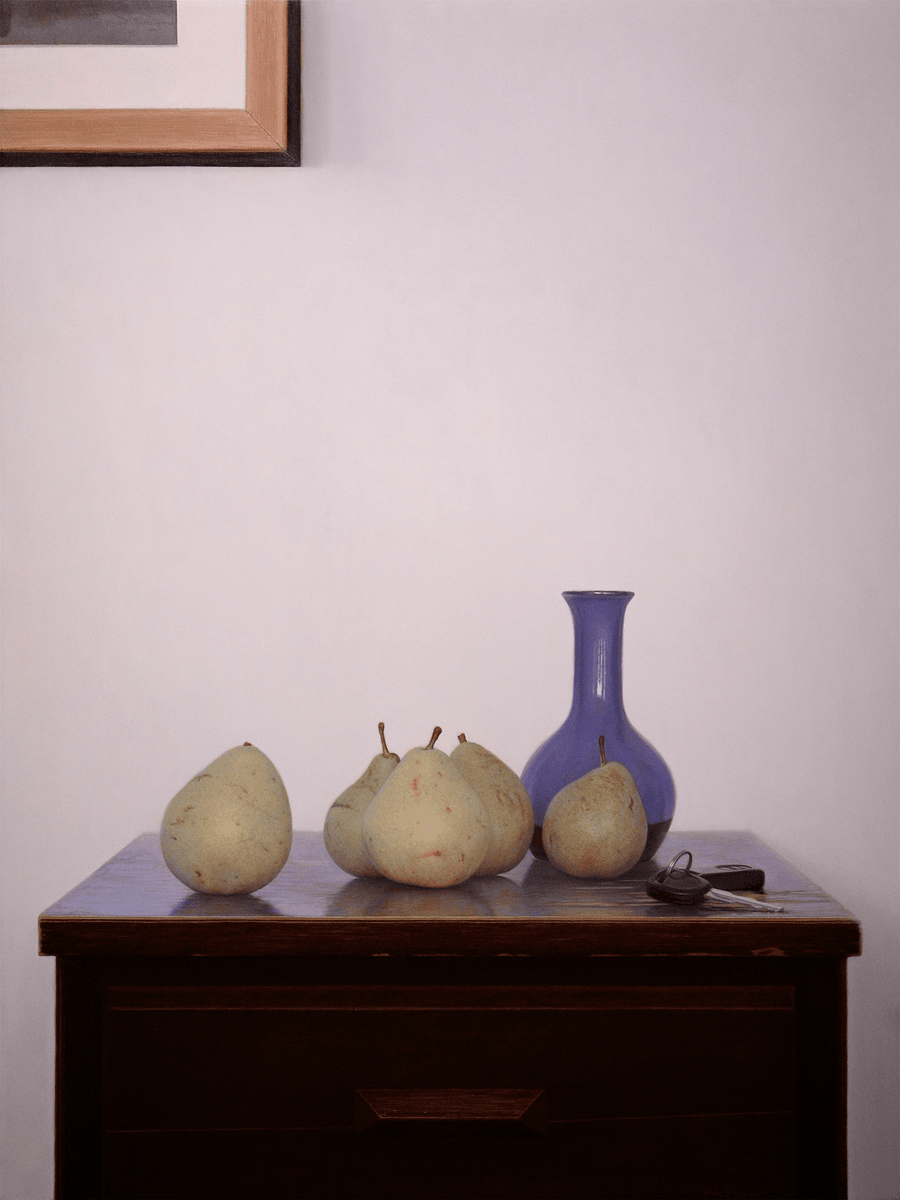 A contemporary realist still life oil painting titled 'Pears on a Table.' Five green-mottled pears are grouped on the dark, polished surface of a wooden chest of drawers alongside a slender, bulbous purple vase and a set of car keys. The scene is set against a neutral, off-white wall, with a portion of a wooden picture frame visible in the upper left. Soft, cool light illuminates the subjects, casting gentle shadows and creating delicate reflections on the tabletop. Oil painting by John Hansen.