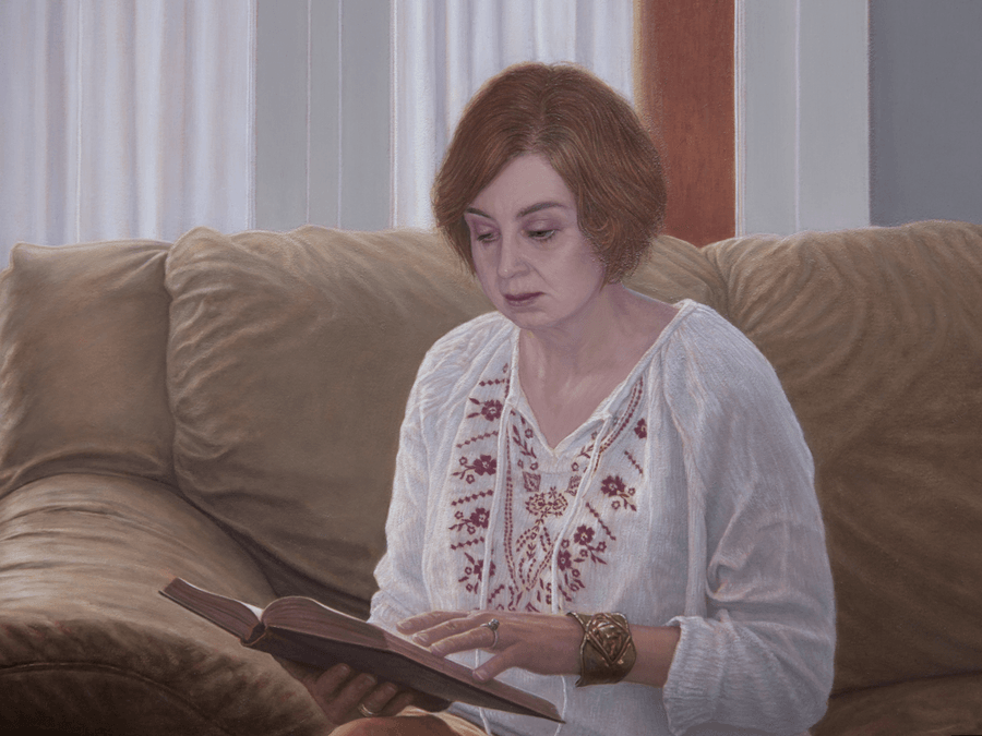 A detailed close-up from the oil painting 'Woman Reading'. This view focuses on the woman's head and the upper portion of the book. It showcases the fine, realistic rendering of her skin tones under warm light and the focused expression on her face. The detail reveals the subtle brushwork used to create the soft shadows on her neck and the crisp edges of the book's pages. Oil painting by John Hansen.